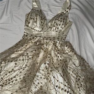Gold and white sparkly quince dress.